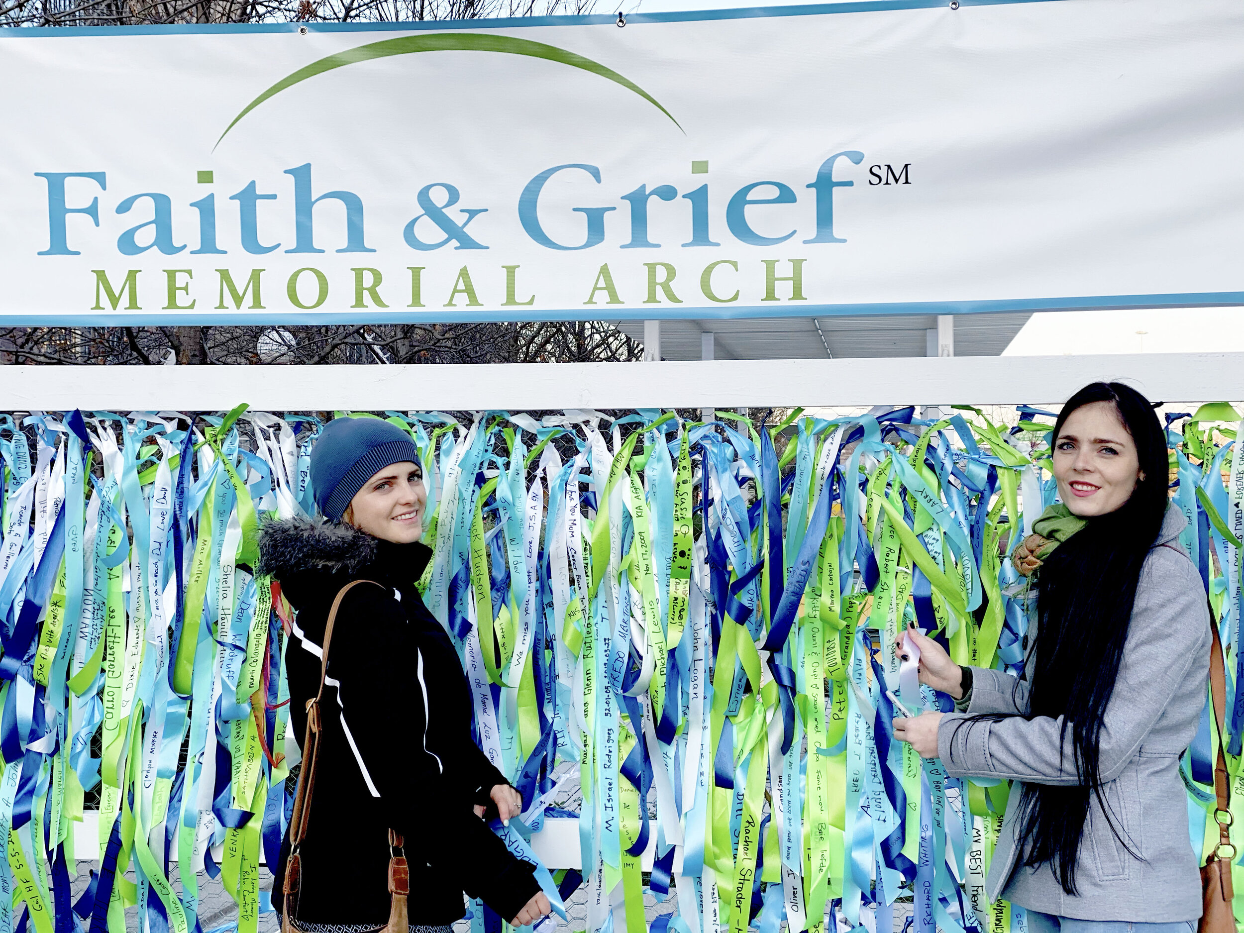 Faith & Grief Memorial Arch two women visit