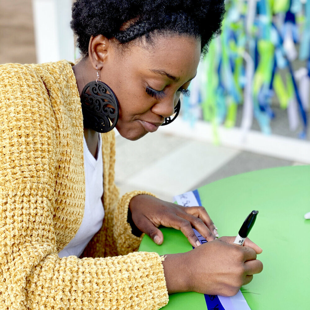 Faith & Grief woman writing ribbon