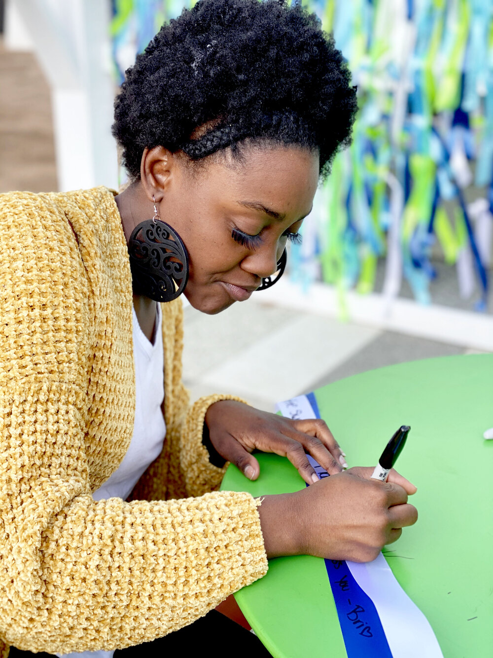 Faith & Grief woman writing ribbon